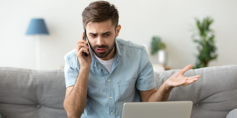 Frustrated man on the phone learning about his sale falling through. 