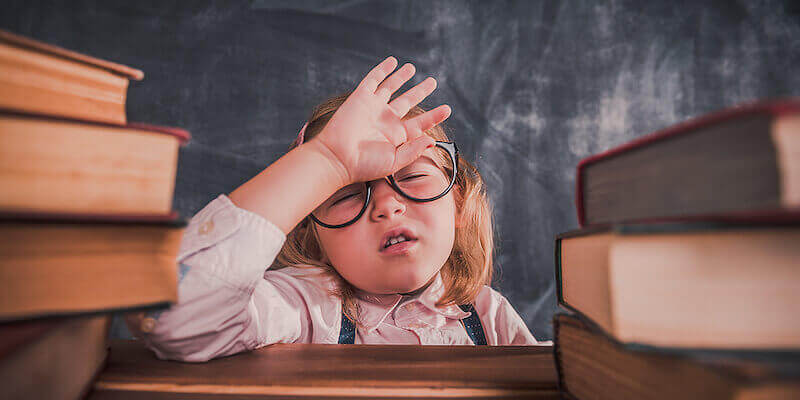 Image of a tired kid studying - What is stamp duty (and how much is it, who pays stamp duty, etc)