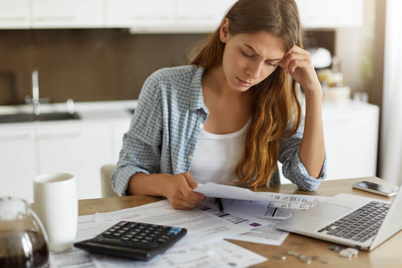 A lady working out the costs involved in selling an inherited house.