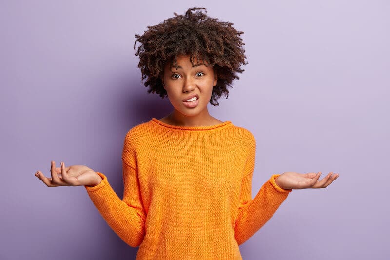 A woman shrugging her shoulders.