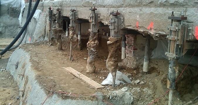 An example or underpinning, where the foundations are supported with metal "pins". 